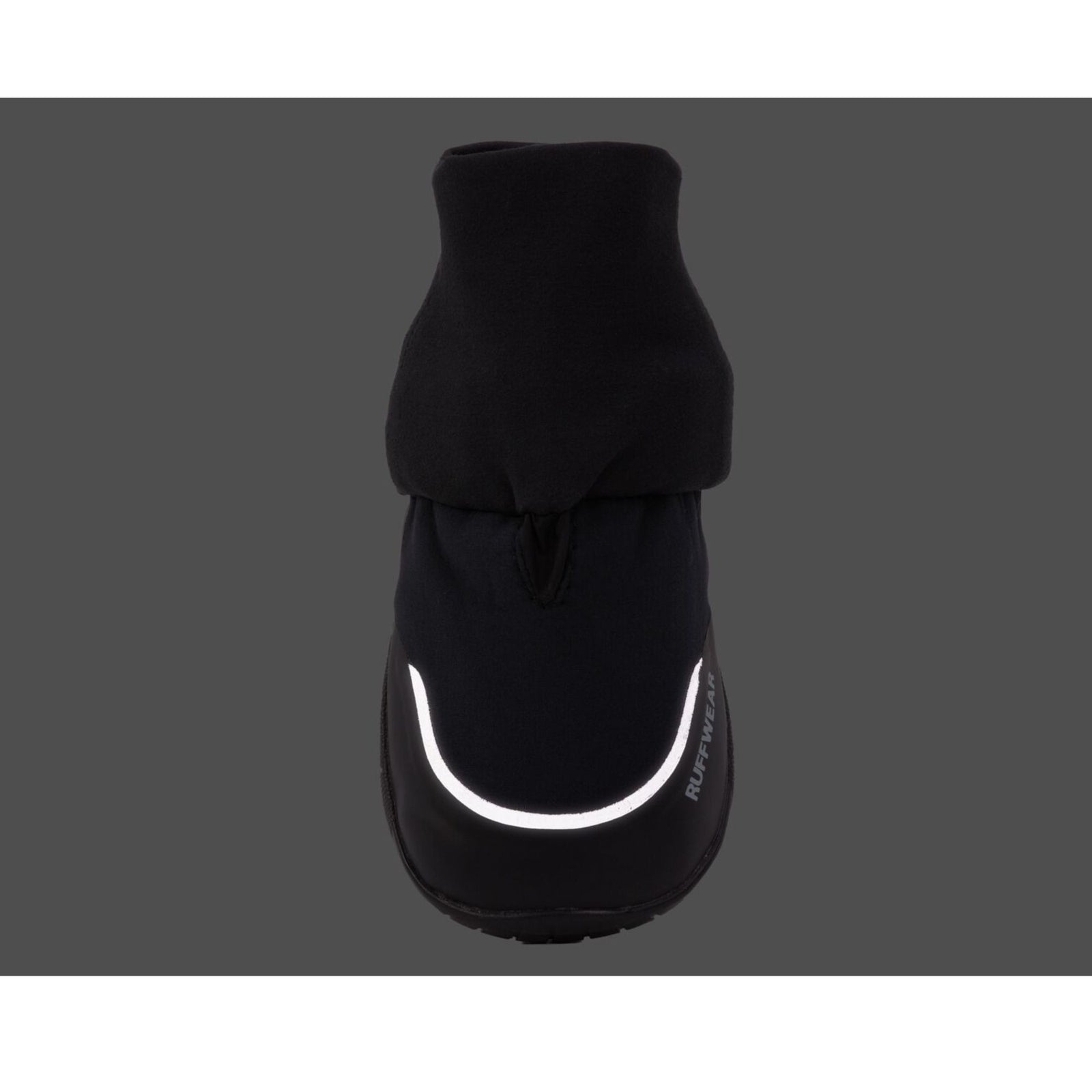 Ruffwear Polar Trex Winter Dog Boot on dark background showing reflective trim illuminated for low-light and night visibility