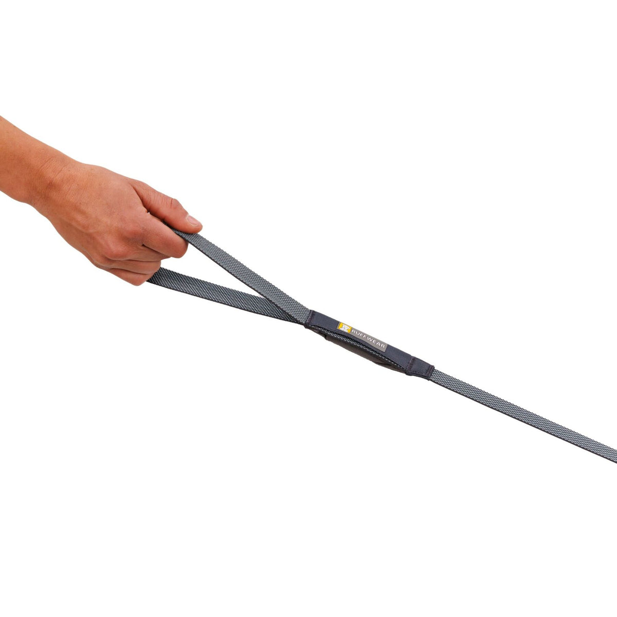 Close-up of a hand holding the Ruffwear Hi &amp; Light Dog Lead in Basalt Gray, showing the minimal webbing and handle