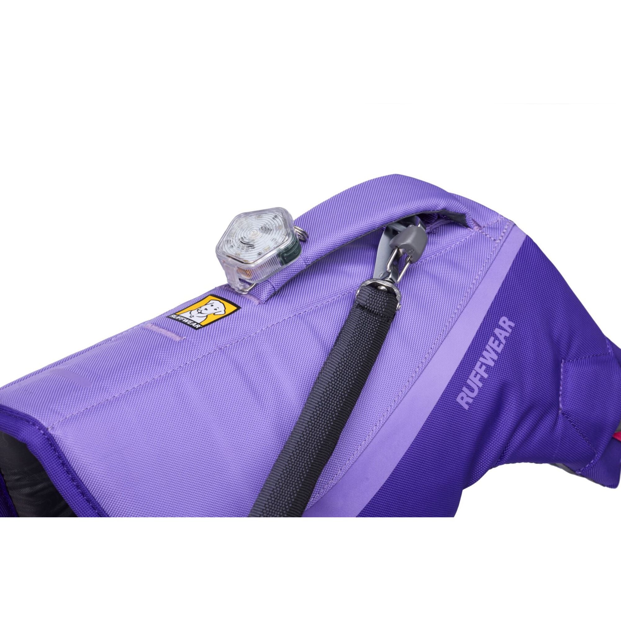 Close-up of the Ruffwear Float Coat handle, leash attachment point, and beacon light loop detail in Purple Lily.