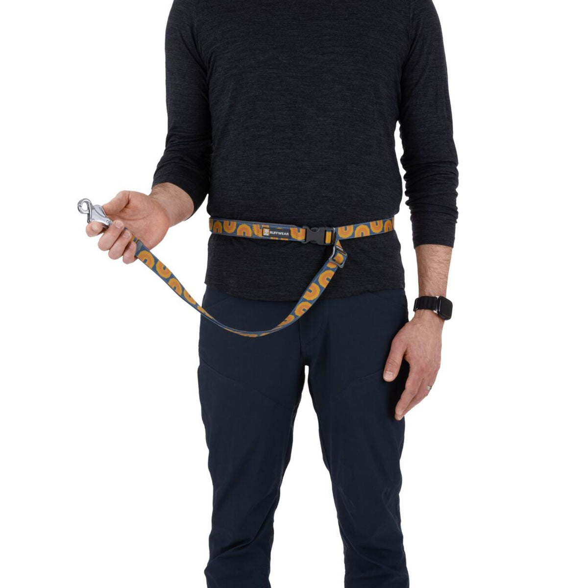 The Ruffwear Crag Lead in Canyon Oxbow worn as a hands-free lead around a person's waist, clipped to the buckle, with the lead extending forward — showing the hands-free running configuration. 