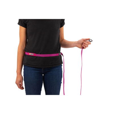 Ruffwear Flagline Dog Lead worn around waist in hands-free configuration in Alpenglow Pink