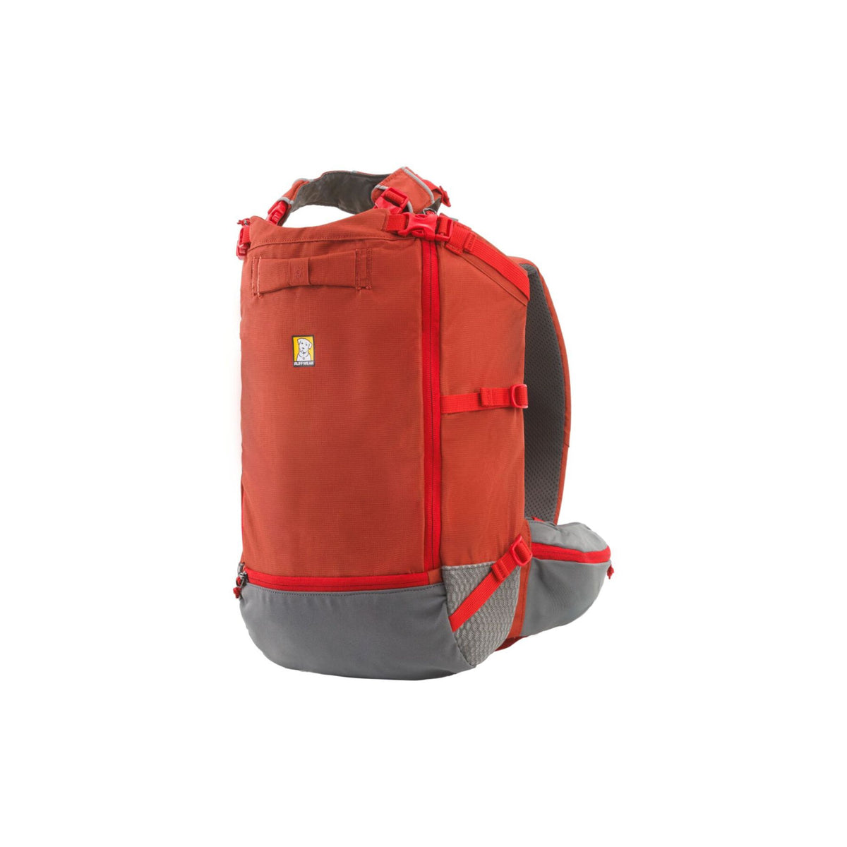 Ruffwear Hitch Hiker dog backpack carrier in Red Clay on a white background, shown from the side, displaying the grab handle, dual locking zippers, cinch strap