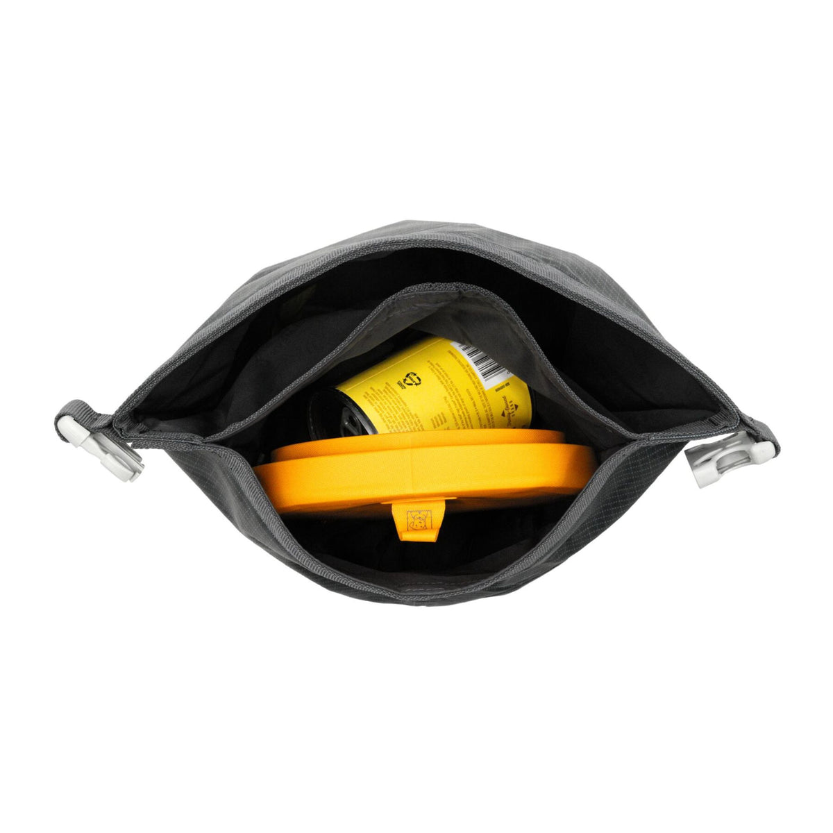 Ruffwear Kibble Kaddie dog food carrier in Basalt Gray open on a white background, showing the internal storage compartment containing a collapsed yellow Ruffwear Dog Bowl