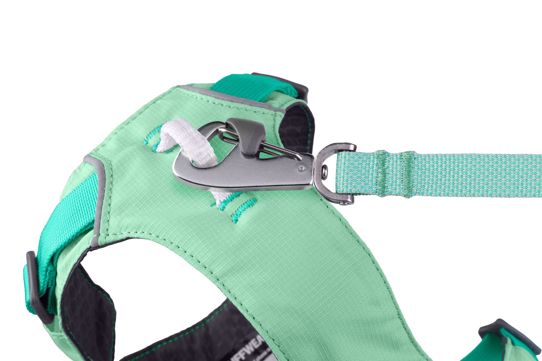 Close-up of the aluminium V-ring leash attachment point on the Ruffwear Hi & Light dog harness in Sage Green, with the matching Hi & Light lead clipped on, on white background